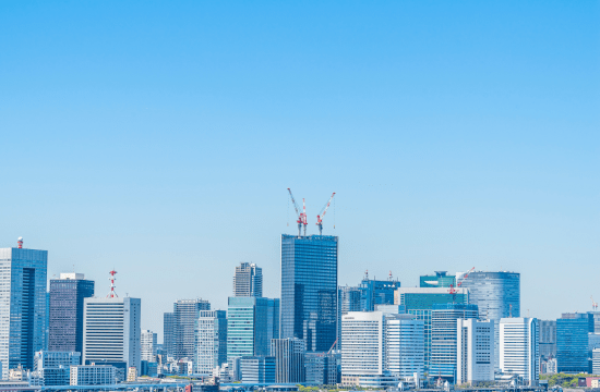 City skyline with cranes on skyscrapers symbolizing Cerity Global's services for global market entry and business setup