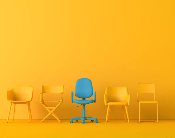 A series of chairs set before a yellow wall, representing the "Interim Hiring via PEO Model" offered by Cerity Global.